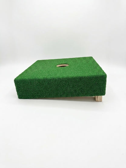 Side view of 20-inch washer toss board with green turf